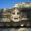 Theatrical mask stone carving of ancient town of Myra in Lycia region, ancient city of Myra in Demre, Turkey Royalty Free Stock Photo