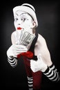 Theatrical mime with dollars in their hands