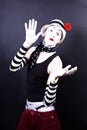 Theatrical mime in white hat with red flower Royalty Free Stock Photo