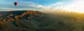 The Theban mountains on the east bank of the Nile near Luxor, Egypt as a flotilla of hot air