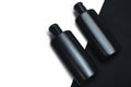 Theblack plastic bottle two bottles with clipping path on black background with rough texture before has a white back suitable for