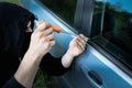 Theft of the car. Man is opening the door. Carjacking of vehicle. Robbing and crime Royalty Free Stock Photo