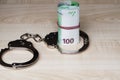 Theft of official money from the country budget, concept.The concept of corruption. Money and handcuffs. Punishment for a bribe Royalty Free Stock Photo