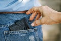 Theft of purse from a jeans pocket in the daytime on the street Royalty Free Stock Photo