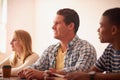 Their journey ahead is filled with so many possibilities. a group of university students sitting in class.