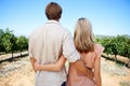Their love flourishes in the great outdoors. Rear view shot of a mature couple enjoying a day in the vineyards.