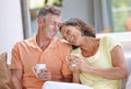 Their love is still going strong. a loving mature couple having coffee while sitting on the sofa. Royalty Free Stock Photo