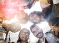 Their minds shape the city. Low angle portrait of a team of happy colleagues putting their heads together in a huddle in