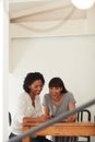 Their mobile app is ready to hit the market. two young businesswomen using a mobile phone together in a modern office. Royalty Free Stock Photo