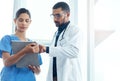 Their patients are in good hands. two young doctors using a digital tablet in a modern hospital. Royalty Free Stock Photo