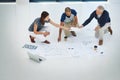 Their space to get creative. High angle shot of three businesspeople working on the floor in their office. Royalty Free Stock Photo