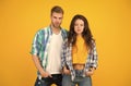 Their style is a lot more casual. Couple in casual wear. Vogue models yellow background. Fashion clothes. Contemporary Royalty Free Stock Photo