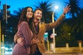 On their way home, but the dates not over. a handsome young man hailing a cab while out on a date with his girlfriend in Royalty Free Stock Photo