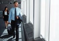 On their way to the top. two executive businesspeople walking through an airport during a business trip. Royalty Free Stock Photo