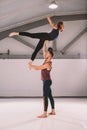 The theme of Acroyoga and Yoga Poses. A pair of two men and a woman stand in the position of asana. The guy holds the girl arched