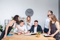 Theme is business and teamwork. A group of young Caucasian people office workers holding a meeting, briefing, working with papers Royalty Free Stock Photo