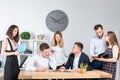 Theme is business and teamwork. A group of young Caucasian people office workers holding a meeting, briefing, working with papers Royalty Free Stock Photo