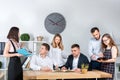 Theme is business and teamwork. A group of young Caucasian people office workers holding a meeting, briefing, working with papers Royalty Free Stock Photo