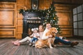 Theme Christmas and New Year family circle. Young Caucasian family with 1 year old child dog breed Labrador Golden Retriever Royalty Free Stock Photo