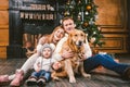 Theme Christmas and New Year family circle. Young Caucasian family with 1 year old child dog breed Labrador Golden Retriever Royalty Free Stock Photo