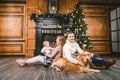 Theme Christmas and New Year family circle. Young Caucasian family with 1 year old child dog breed Labrador Golden Retriever Royalty Free Stock Photo