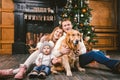 Theme Christmas and New Year family circle. Young Caucasian family with 1 year old child dog breed Labrador Golden Retriever Royalty Free Stock Photo