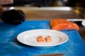 Theme cooking is a profession of cooking. Close-up of a Caucasian man`s hand in a restaurant kitchen preparing red fish fillets