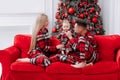 The theme of the family holiday is New year and Christmas. Young European family in the same pyjamas: mom, dad, baby boy Royalty Free Stock Photo