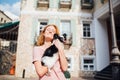 The theme is the friendship of man and animal. Beautiful young red hair Caucasian woman holding a pet dog Chihuahua breed near a Royalty Free Stock Photo