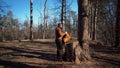 Theme hiking and travel. A Caucasian tourist man unpacks an orange backpack, takes out his things and puts them on a stump in the