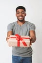 Black man holding gift in white box wrapped with red ribbon and bow Royalty Free Stock Photo