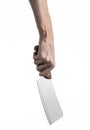 The theme of the kitchen: Chef hand holding a large kitchen knife for cutting meat on a white background isolated Royalty Free Stock Photo