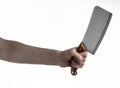 The theme of the kitchen: Chef hand holding a large kitchen knife for cutting meat on a white background isolated Royalty Free Stock Photo