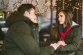 Theme love holiday Valentines Day. pair college students, Caucasian heterosexual lovers in winter, sit table of street cafe Royalty Free Stock Photo