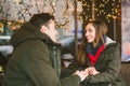 Theme love holiday Valentines Day. pair college students, Caucasian heterosexual lovers in winter, sit table of street cafe Royalty Free Stock Photo