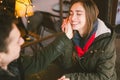 Theme love holiday Valentines Day. pair college students, Caucasian heterosexual lovers in winter, sit table of street cafe Royalty Free Stock Photo