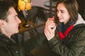 Theme love holiday Valentines Day. pair college students, Caucasian heterosexual lovers in winter, sit table of street cafe Royalty Free Stock Photo