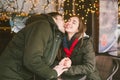 Theme love holiday Valentines Day. pair college students, Caucasian heterosexual lovers in winter, sit table of street cafe Royalty Free Stock Photo