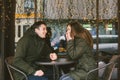 Theme love holiday Valentines Day. pair college students, Caucasian heterosexual lovers in winter, sit table of street Royalty Free Stock Photo