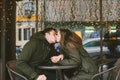 Theme love holiday Valentines Day. pair college students, Caucasian heterosexual lovers in winter, sit table of street Royalty Free Stock Photo