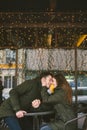 Theme love holiday Valentines Day. pair college students, Caucasian heterosexual lovers in winter, sit table of street Royalty Free Stock Photo