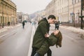 Theme love and romance. Caucasian young people heterosexual couple in love students boyfriend girl hugging and kissing on center Royalty Free Stock Photo