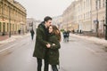 Theme love and romance. Caucasian young people heterosexual couple in love students boyfriend girl hugging and kissing on center Royalty Free Stock Photo