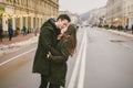 Theme love and romance. Caucasian young people heterosexual couple in love students boyfriend girl hugging and kissing on center Royalty Free Stock Photo