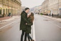 Theme love and romance. Caucasian young people heterosexual couple in love students boyfriend girl hugging and kissing on center Royalty Free Stock Photo