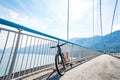 Theme of mountain biking in Scandinavia. human tourist in helmet and sportswear on bicycle in Norway on Hardanger Bridge Royalty Free Stock Photo