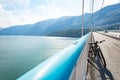 Theme of mountain biking in Scandinavia. human tourist in helmet and sportswear on bicycle in Norway on Hardanger Bridge Royalty Free Stock Photo