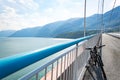 Theme of mountain biking in Scandinavia. human tourist in helmet and sportswear on bicycle in Norway on Hardanger Bridge Royalty Free Stock Photo