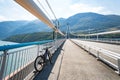 Theme of mountain biking in Scandinavia. human tourist in helmet and sportswear on bicycle in Norway on Hardanger Bridge Royalty Free Stock Photo