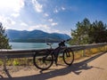 Theme of mountain biking in Scandinavia. human tourist in helmet and sportswear on bicycle in Norway on Hardanger Bridge Royalty Free Stock Photo